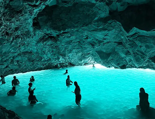 Swimming inside Blue Cave with glowing turquoise water during boat tour from Vlore