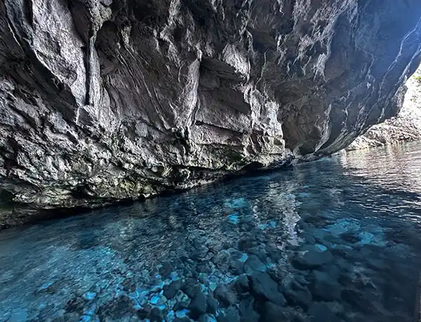 Clear water and rocky cave formations on Karaburun Peninsula during boat tour from Vlore